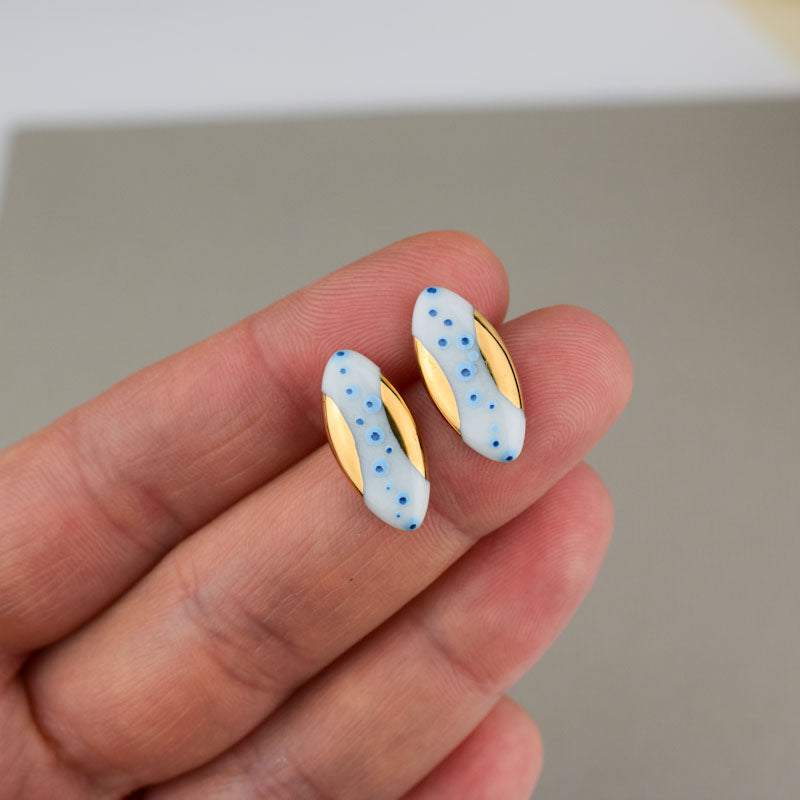 Porcelain stud earrings created and hand-painted by Vali Bondoc with high temperature ceramic dyes and colloidal gold