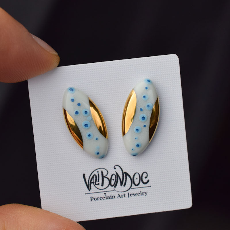 Porcelain stud earrings created and hand-painted by Vali Bondoc with high temperature ceramic dyes and colloidal gold