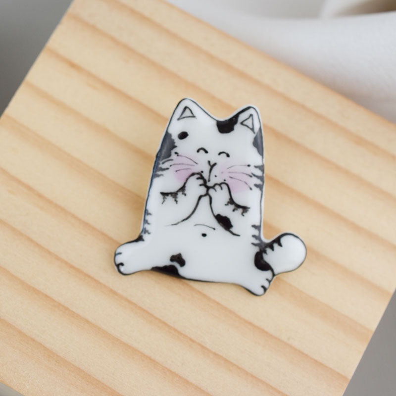 Topy cat. Porcelain brooch created and hand-painted by Vali Bondoc with high temperature ceramic dyes
