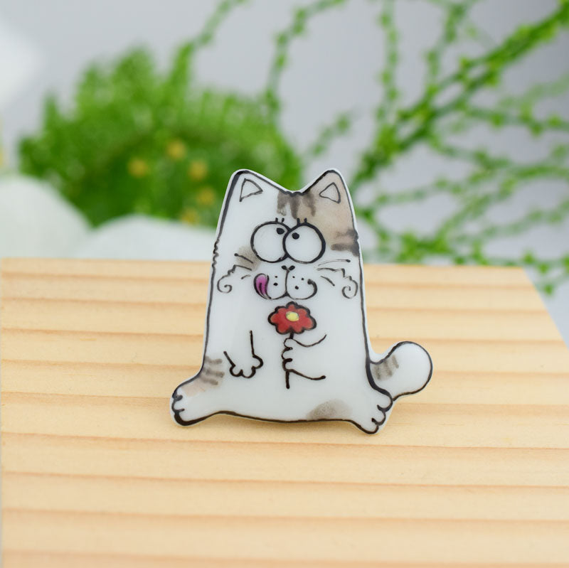 Topy cat. Porcelain brooch created and hand-painted by Vali Bondoc with high temperature ceramic dyes and colloidal gold.