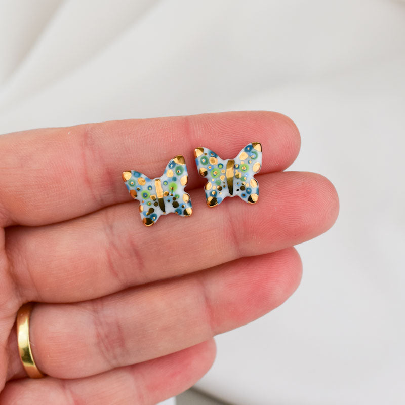 Porcelain stud earrings created and hand-painted by Vali Bondoc with high temperature ceramic dyes and colloidal gold