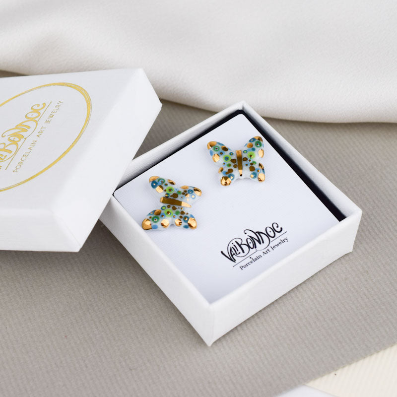 Porcelain stud earrings created and hand-painted by Vali Bondoc with high temperature ceramic dyes and colloidal gold