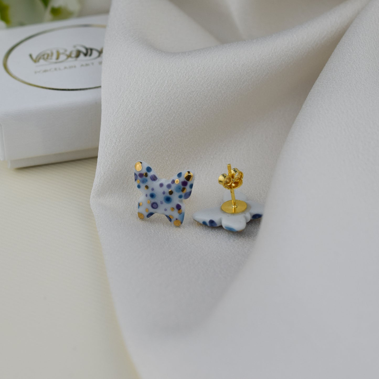 Butterfly. Porcelain stud earrings created and hand-painted by Vali Bondoc with high temperature ceramic dyes and colloidal gold