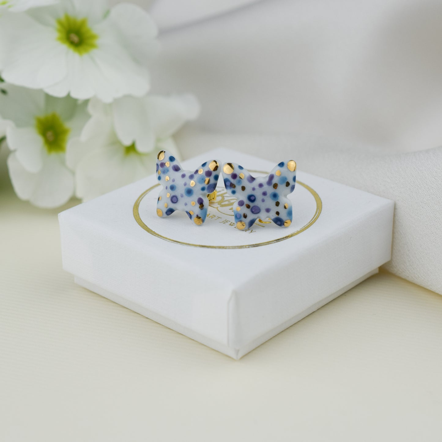 Butterfly. Porcelain stud earrings created and hand-painted by Vali Bondoc with high temperature ceramic dyes and colloidal gold