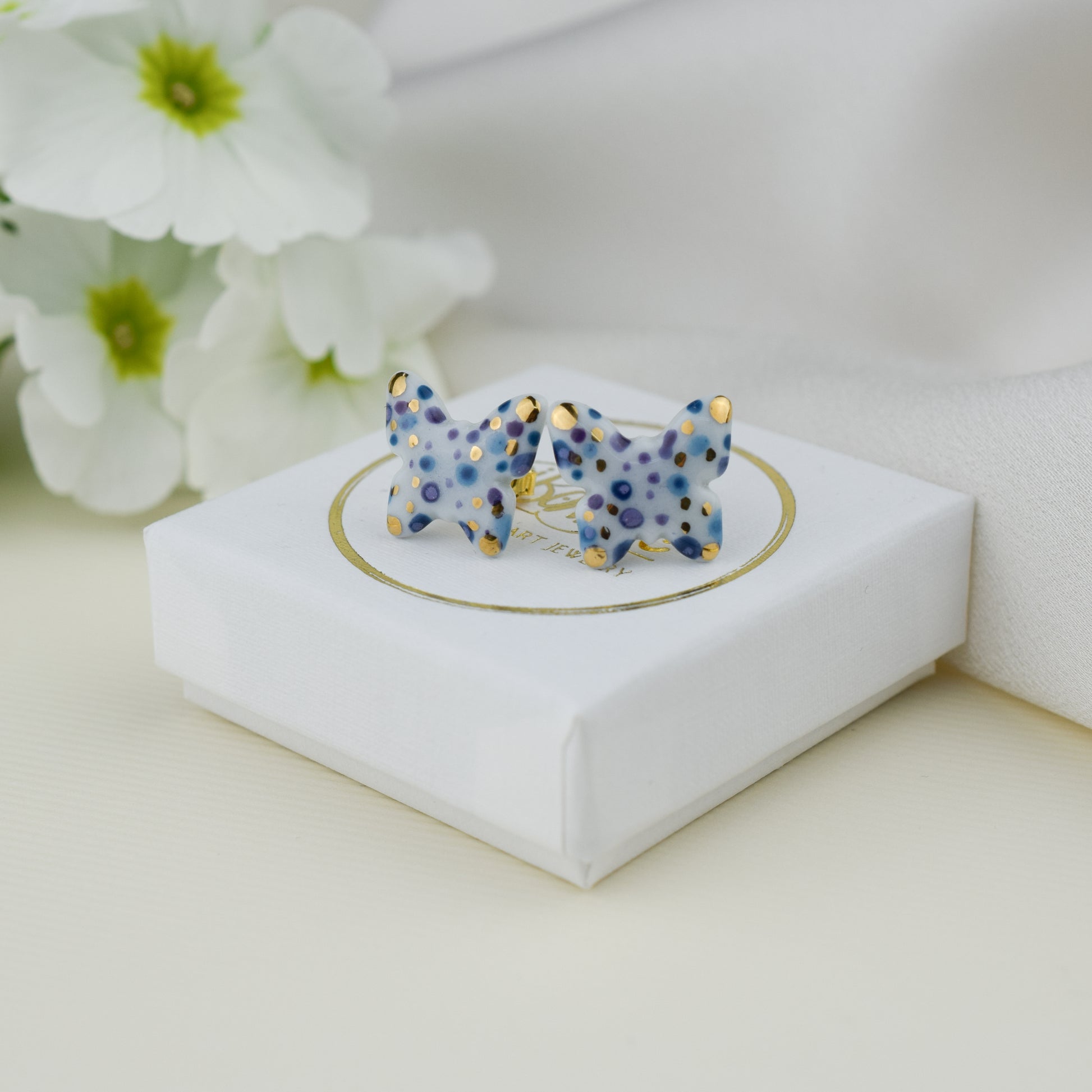 Butterfly. Porcelain stud earrings created and hand-painted by Vali Bondoc with high temperature ceramic dyes and colloidal gold