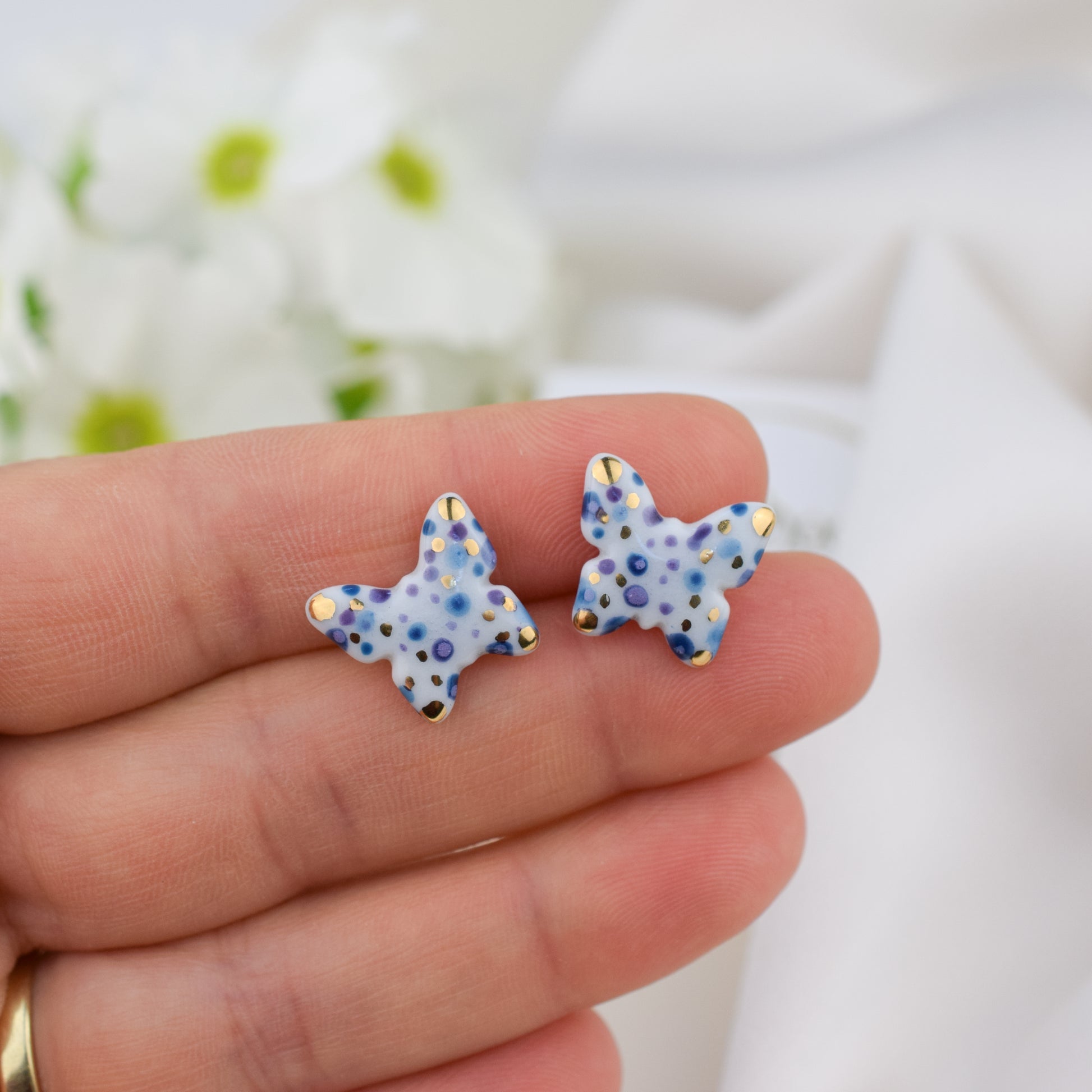 Butterfly. Porcelain stud earrings created and hand-painted by Vali Bondoc with high temperature ceramic dyes and colloidal gold