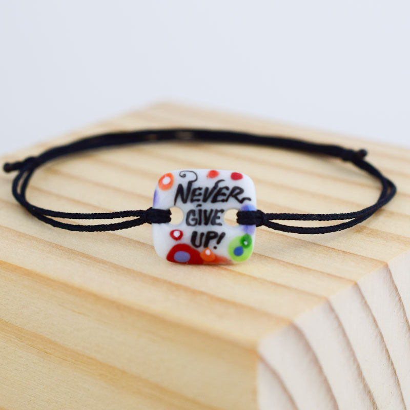 Never give up. Porcelain bracelet handmade and hand painted by Vali Bondoc