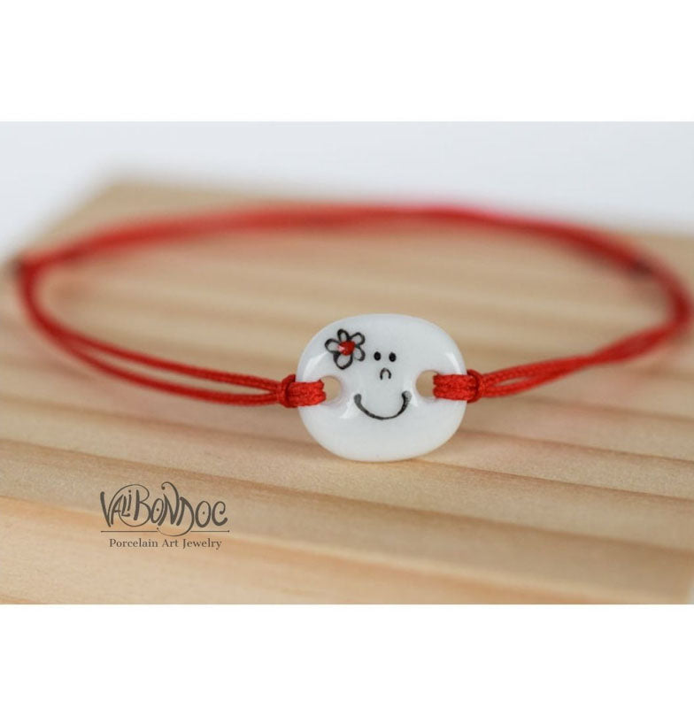 Smiley face with flower .Porcelain bracelet handmade and hand painted by Vali Bondoc