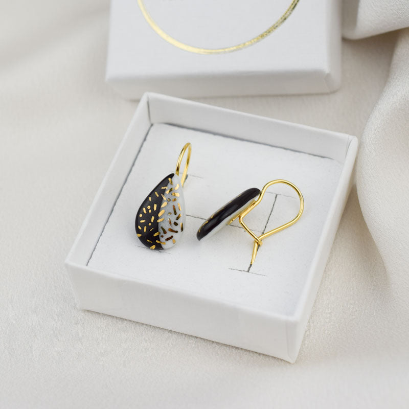 Porcelain hook earrings created and hand-painted by Vali Bondoc with high temperature ceramic dyes and colloidal gold
