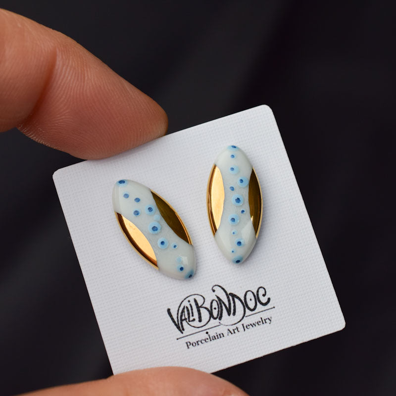 Porcelain stud earrings created and hand-painted by Vali Bondoc with high temperature ceramic dyes and colloidal gold
