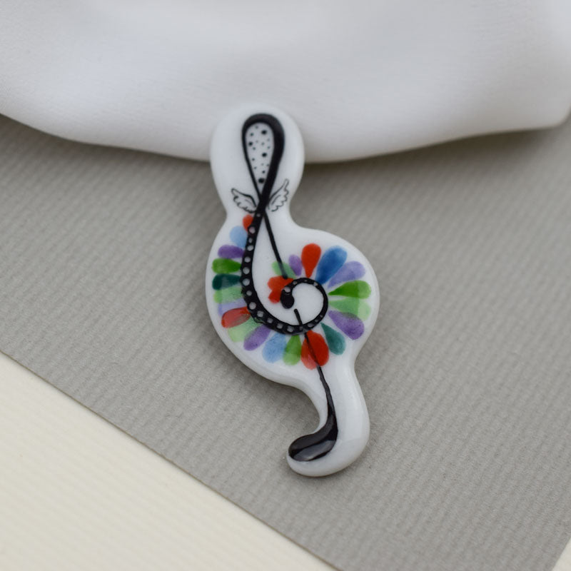 Porcelain brooch created and hand-painted by Vali Bondoc with high temperature ceramic dyes and colloidal gold.