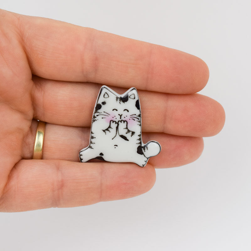 Topy cat. Porcelain brooch created and hand-painted by Vali Bondoc with high temperature ceramic dyes and colloidal gold.