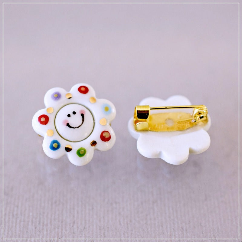 Happy flower. Little porcelain brooch modeled and painted by Vali Bondoc
