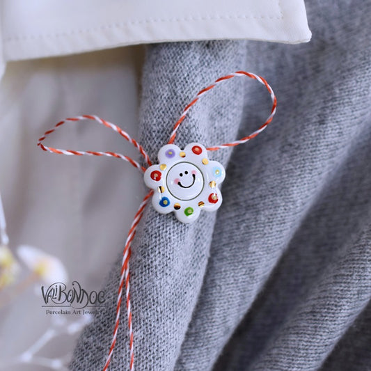 Happy flower. Little porcelain brooch modeled and painted by Vali Bondoc